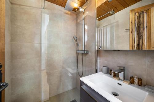 a bathroom with a shower and a sink at Résidence Roc Mugnier - Chalets pour 8 Personnes 504 in Courchevel