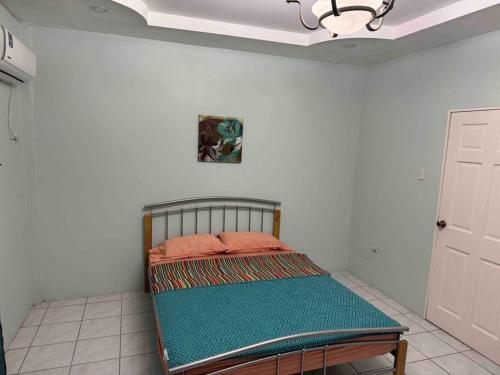 A bed or beds in a room at Townhouse in Diego Martin