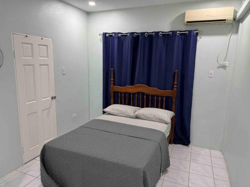 A bed or beds in a room at Townhouse in Diego Martin