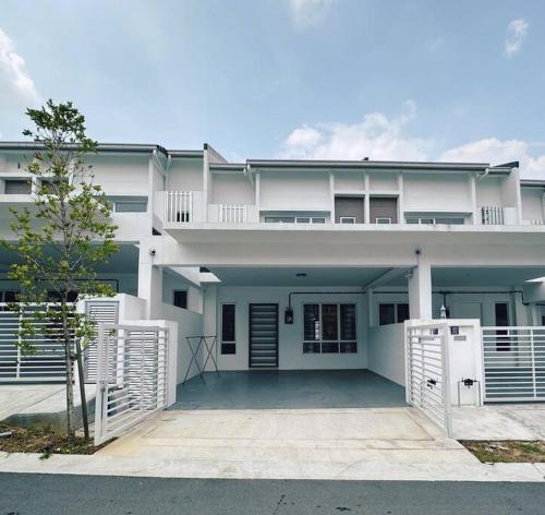 a large white house with a gate in front of it at 12pax（free wifi）@星愿@Star WISH homestay in Labu
