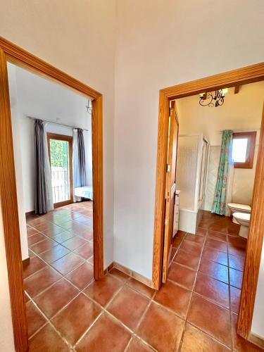 a living room with a tile floor and a mirror at Finca Ses Barraques in Manacor