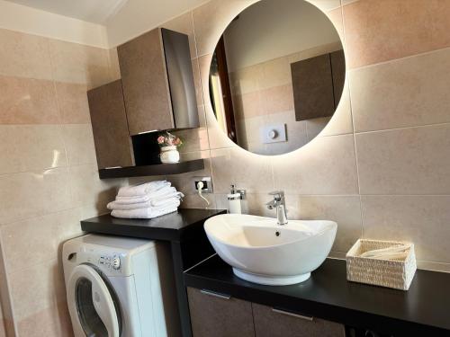a bathroom with a sink and a washing machine at Sweet Home in Lissone