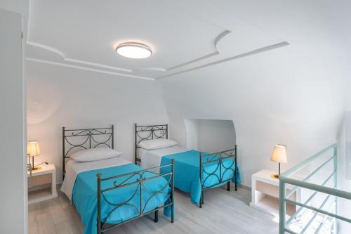 a room with two beds and a staircase at [Amalfi Coast]Elegant house in Penisola Sorrentina in Vico Equense