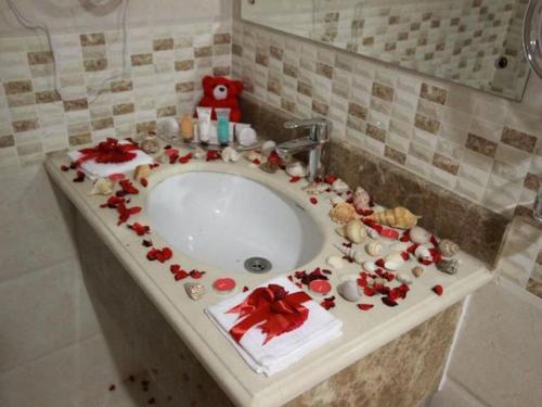 a bathroom sink with christmas decorations on it at بنان فال للشقق المخدومة in Hafr Al Baten