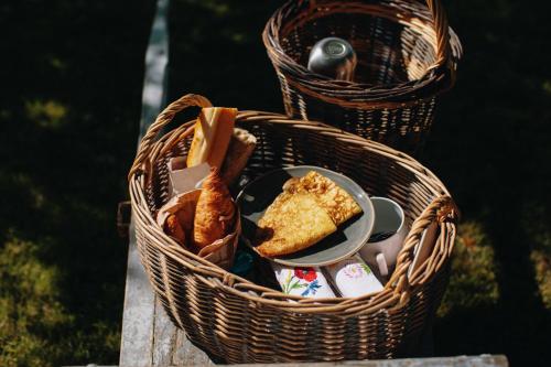 two baskets filled with food on a table at Les gites de Kerégal - la cabane de Charlotte in Plouha