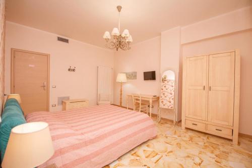 a bedroom with a bed and a desk in it at ROOMS 66 in Campobasso
