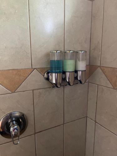 a set of four cups sitting on a wall at Mango Tree Villas in Coronado