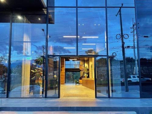 an entrance to a building with glass windows at Hotel Sexto by Icono in Armenia