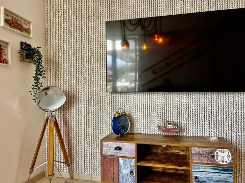 a flat screen tv hanging on a wall at Apartament Klifowy Raj SPA & Restaurant by Stayly in Niechorze