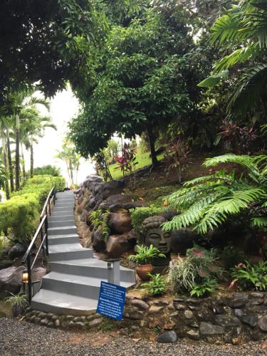 a stairway in a park with a blue sign at Mango Tree Villas in Coronado