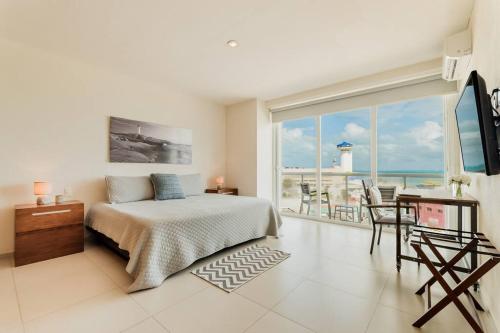a bedroom with a bed and a view of the ocean at *OCEAN Beachfront 4 BDR with pool by Casa Paraiso* in Cancún
