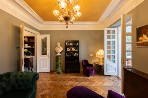 a living room with a ceiling with a chandelier at Eselböck Villa Valter - Historic seaside House in Lovran in Lovran