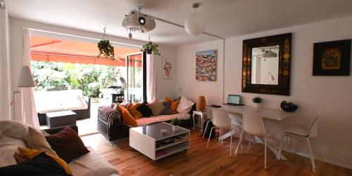 a living room with a table and a dining room at 3-Bed House with Amazing Garden in London