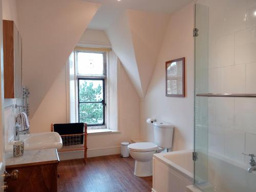 a bathroom with a toilet and a sink and a shower at Haslington House in Malvern Wells