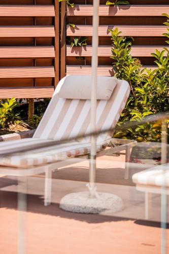 a white bench sitting on top of a glass table at 4RosesVillas in Litochoro