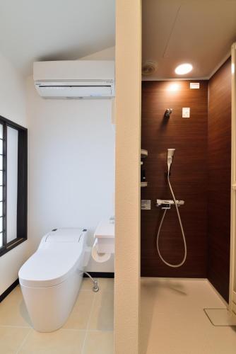 a bathroom with a toilet and a shower at Takeya Kitano Honkan in Kyoto