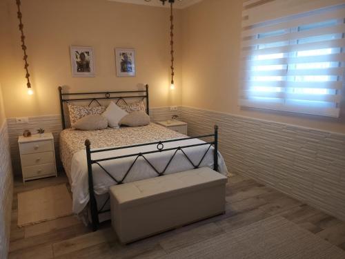 a bedroom with a bed and a window at Suite Huelva garden in Aljaraque