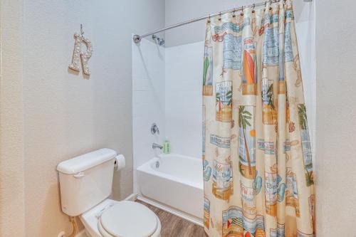 a bathroom with a toilet and a shower curtain at First-Floor Condo with Pool Access in Mesa! in Mesa