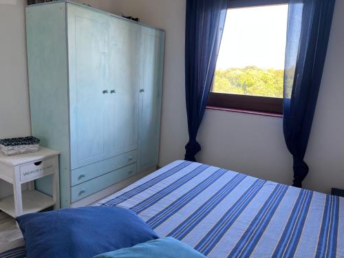 Una cama o camas en una habitación de Porto Coda Cavallo Salina Bamba
