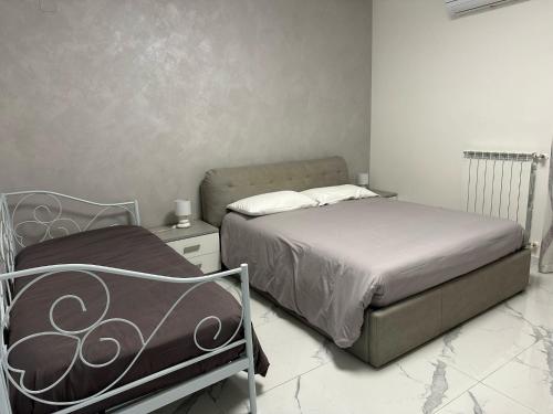 a small bedroom with a bed and a night stand at B&B IL PICCOLO PRINCIPE in Mercato San Severino