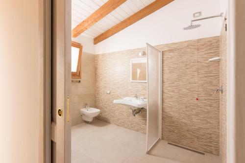 a bathroom with a toilet and a sink at PARADAISE SUITES SEA VIEW SARDINIA, Bedda Ista in Castelsardo
