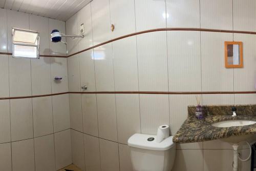 La salle de bains est pourvue de toilettes et d'un lavabo. dans l'établissement Kitinet com 01 quarto, à Vila Velha