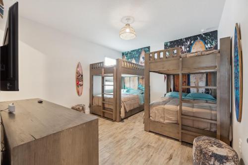 two bunk beds in a room with a table and chairs at Modern 5BR Getaway, PS5 & Board Games - Port St. Lucie, Florida in Carlton