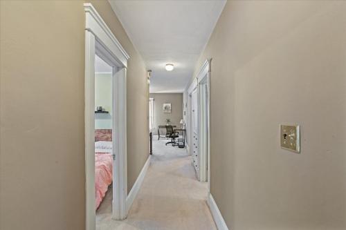 a hallway of a bedroom with a bed and a desk at Greenridge Getaway:Near Universities & Attractions in Scranton