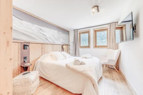 une chambre avec un grand lit blanc et une chaise dans l'établissement Résidence Le Grand Bouquetin - 2 Pièces pour 6 Personnes MAE-9964, à Champagny-en-Vanoise