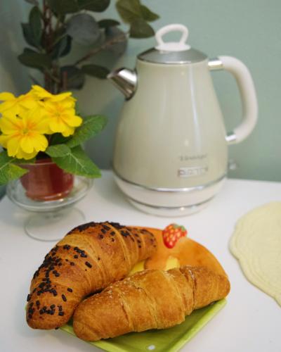 a plate of food with croissants on a table at Il Giardino di Cristina - A literary B&B in Chianti in Vagliagli