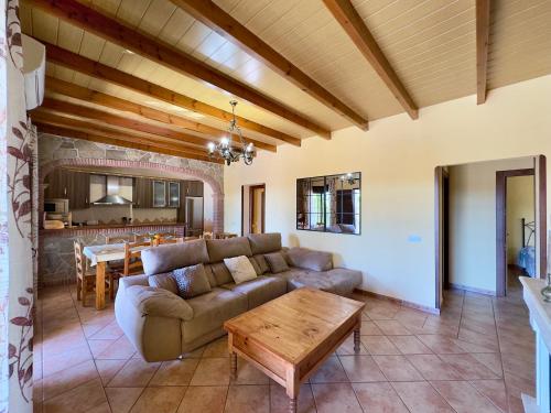 a living room with a couch and a table at Finca La Panorámica in Alhaurín el Grande
