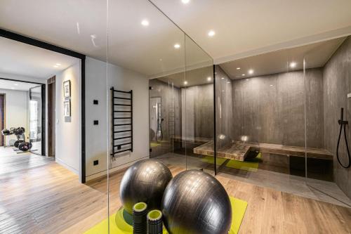 a bathroom with a glass walled shower with a yoga ball at Chalet Quebec - Chalets pour 14 Personnes 454 in Saint-Martin-de-Belleville