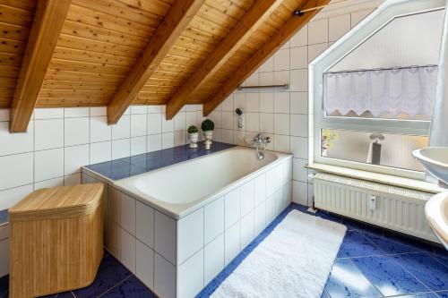 La salle de bains est pourvue d'une baignoire et d'un lavabo. dans l'établissement Ferienwohnung Auf dem Hohen, à Hüfingen