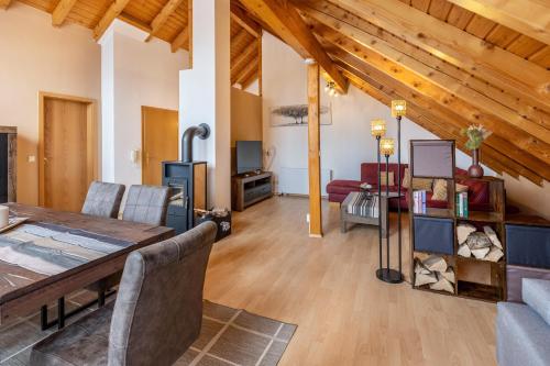 a large living room with a table and a couch at Ferienwohnung Auf dem Hohen in Hüfingen