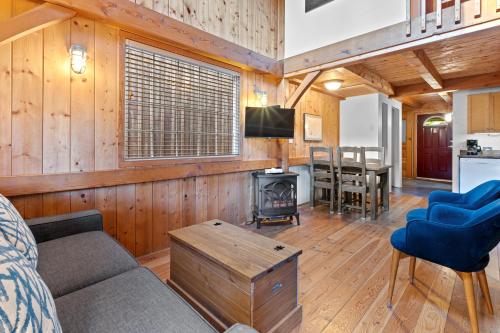 a living room with a couch and a stove at The Cabins at Terrace Beach in Ucluelet