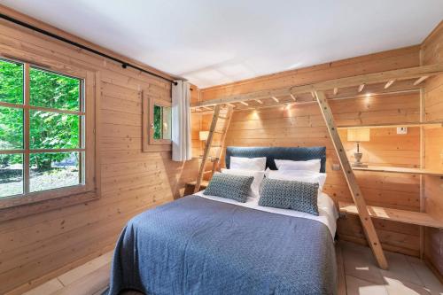 a bedroom with a bed in a wooden room at Résidence Coton - Pièces 544 in Saint-Marcel