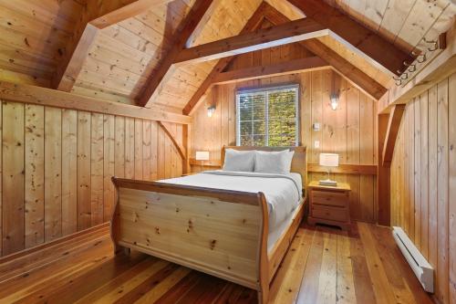a bedroom with a bed in a wooden cabin at The Cabins at Terrace Beach in Ucluelet