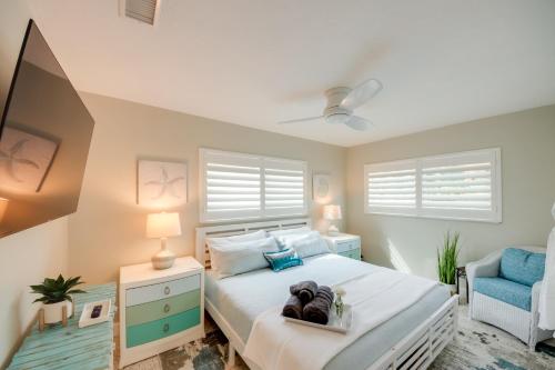 a bedroom with a large bed and a blue chair at Lush Punta Gorda Escape Private Pool and Lanai in Punta Gorda