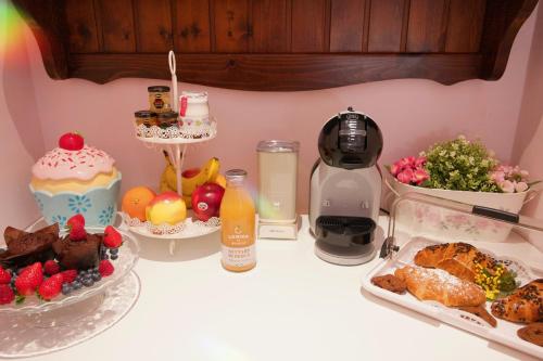 a table topped with food and fruit on a counter at Il Giardino di Cristina in Vagliagli