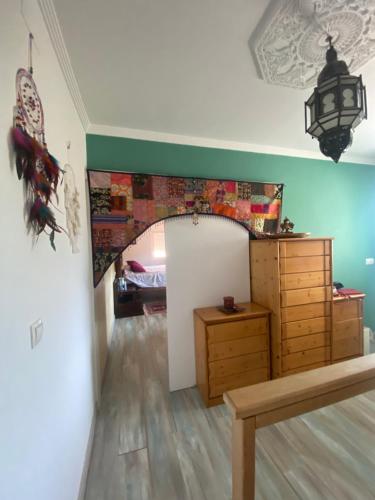 a room with a bedroom with a bed and a dresser at Casa Cruz in Gelves