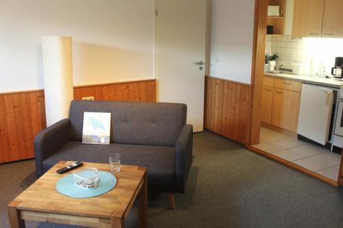 a living room with a couch and a table at Ferienwohnung Struve Nr 2 in Petersdorf auf Fehmarn