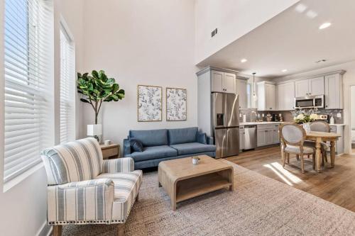 a living room with a blue couch and a table at Cypress House*Cozy, Chic, and yours to book now! in Lafayette