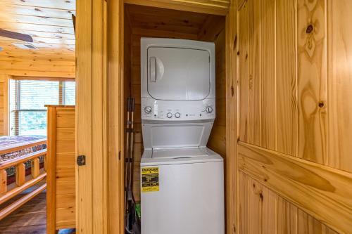 a washer and dryer sitting on top of a refrigerator at Misty Morning Meadow Breathtaking Smoky Mountain Cabin with Hot Tub, Views, & Free Tickets in Cosby
