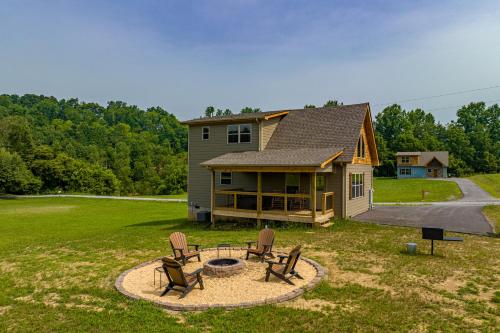 a house with a fire pit and chairs in the yard at Misty Morning Meadow Breathtaking Smoky Mountain Cabin with Hot Tub, Views, & Free Tickets in Cosby