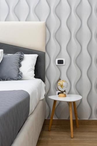 a bedroom with a bed and a side table at MarGab B&B in Naples