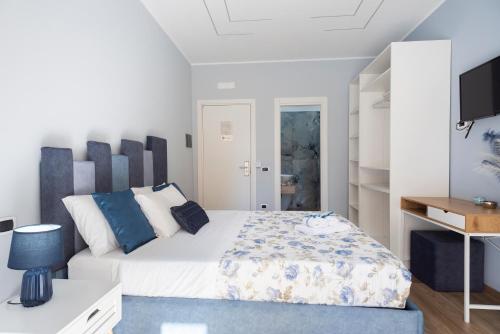 a bedroom with a bed and a tv in it at MarGab B&B in Naples
