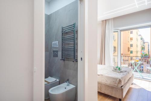 a bathroom with a bed and a tub and a window at MarGab B&B in Naples