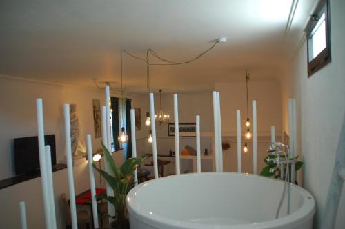 a bathroom with a white tub in a room at HOTELITO RURAL GA7COLORES only adult in Montaña Blanca