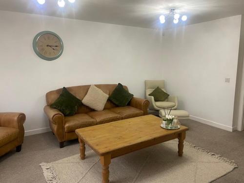a living room with a couch and a coffee table at Shepshed 2 Bedroom Apartment in Shepshed