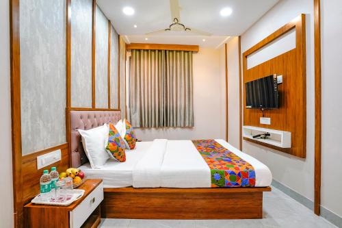 a bedroom with a bed and a table with fruit on it at Hotel Affari in Mumbai